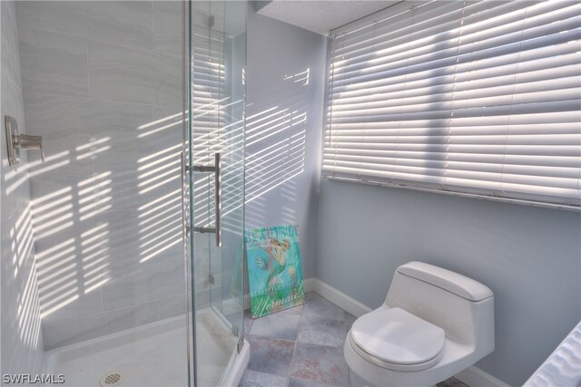 bathroom featuring tile flooring, walk in shower, and toilet