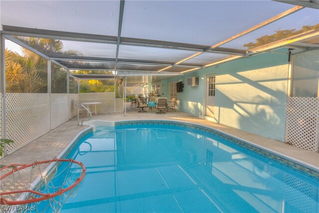 view of swimming pool featuring a patio area and a lanai