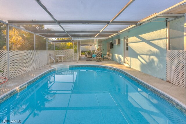 view of pool with a patio and glass enclosure