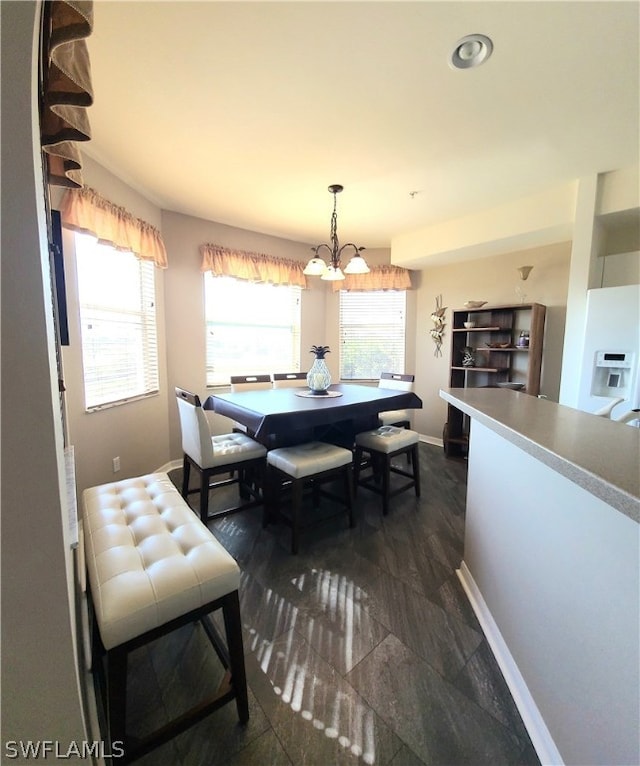 dining area featuring an inviting chandelier