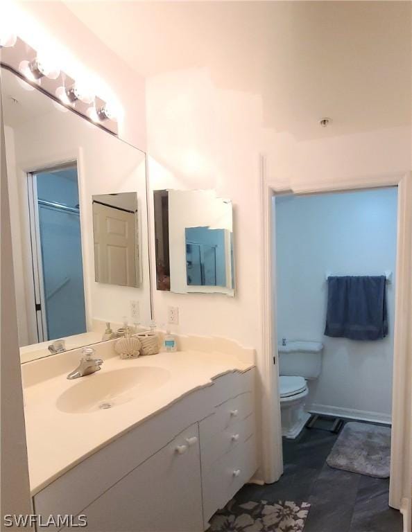 bathroom featuring vanity and toilet