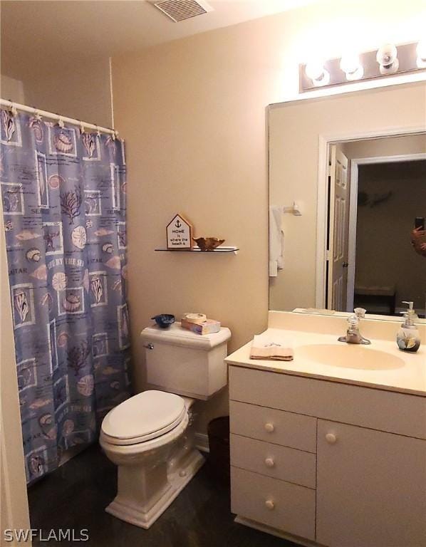 bathroom featuring vanity and toilet