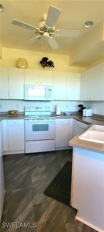 kitchen featuring ceiling fan, white cabinets, and white appliances