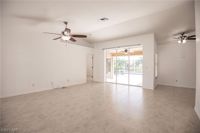 empty room featuring lofted ceiling, ceiling fan, and light tile floors