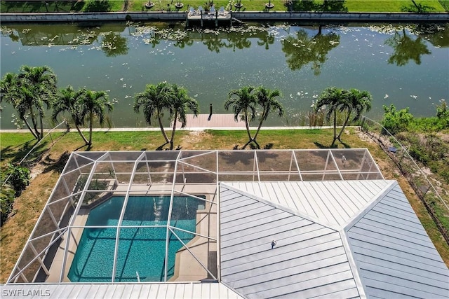 outdoor pool featuring a lanai and a water view