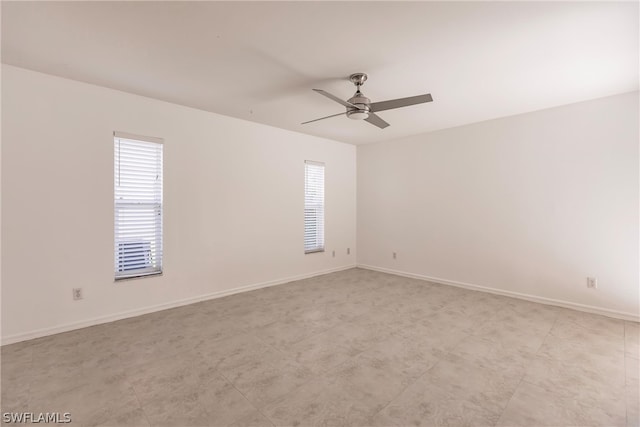 unfurnished room with ceiling fan and light tile floors