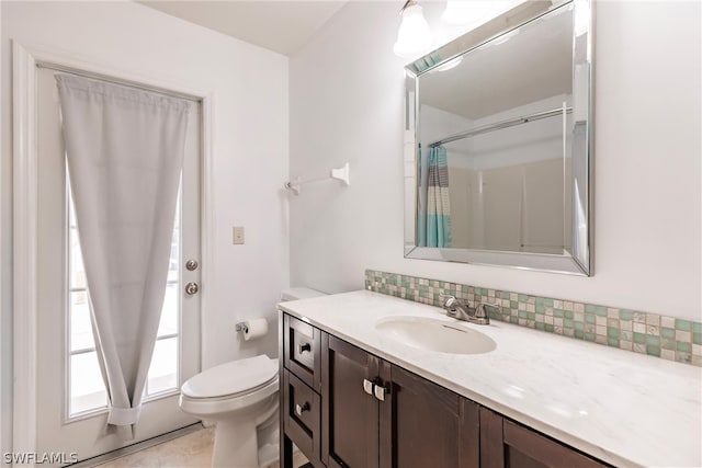 bathroom featuring backsplash, large vanity, toilet, and tile flooring