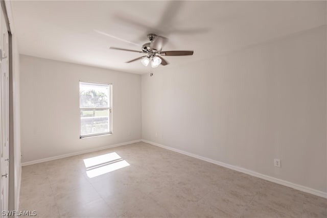 empty room featuring ceiling fan and tile floors