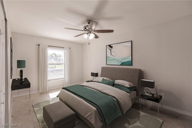 bedroom with ceiling fan and concrete floors