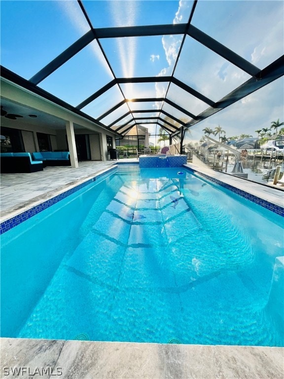 view of pool featuring a lanai, a patio area, and an outdoor hangout area