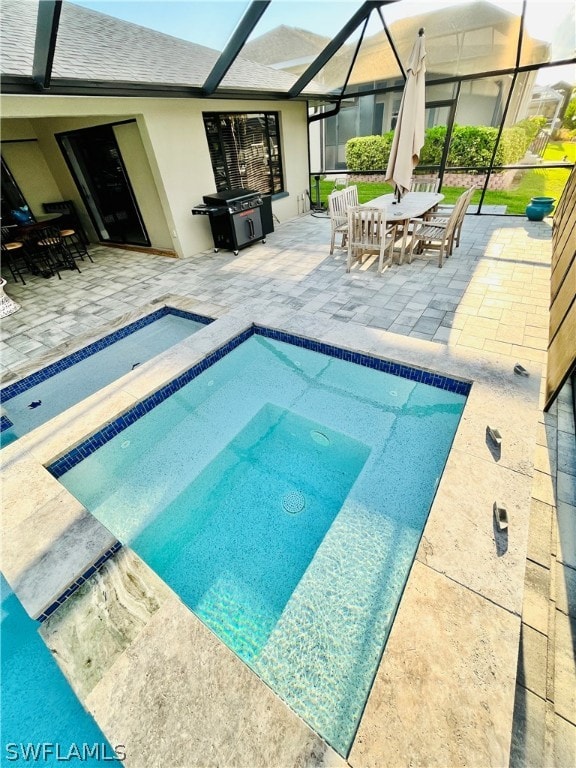 view of swimming pool featuring glass enclosure, a grill, and a patio