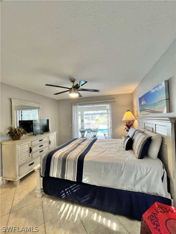 bedroom with light tile patterned floors, a textured ceiling, and ceiling fan