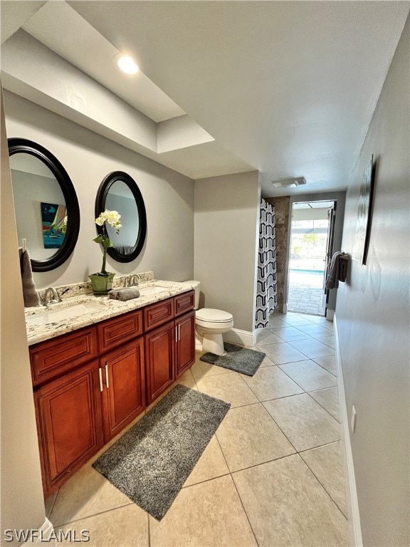 bathroom with tile patterned floors, vanity, and toilet