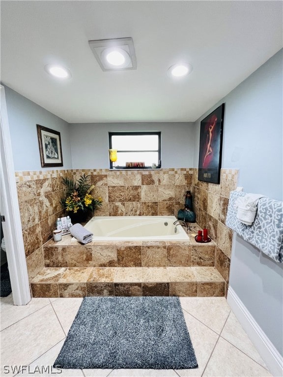 bathroom featuring tile patterned floors and tiled tub