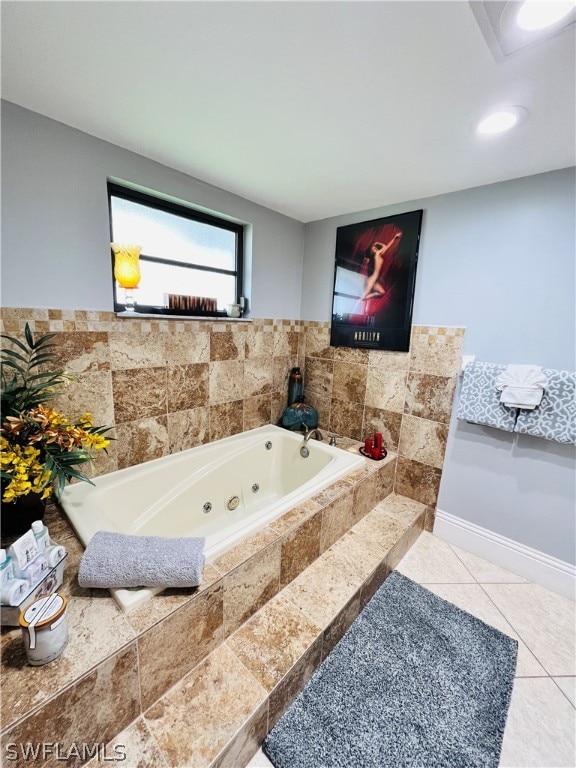 bathroom featuring tile patterned flooring and tiled bath