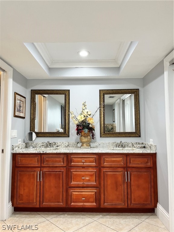 bathroom with vanity, a tray ceiling, tile patterned floors, and ornamental molding