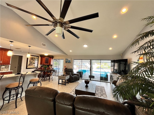 living room with light tile patterned floors, high vaulted ceiling, and ceiling fan