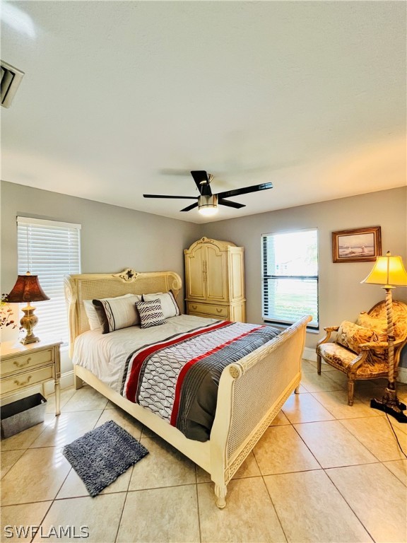 bedroom with light tile patterned floors and ceiling fan