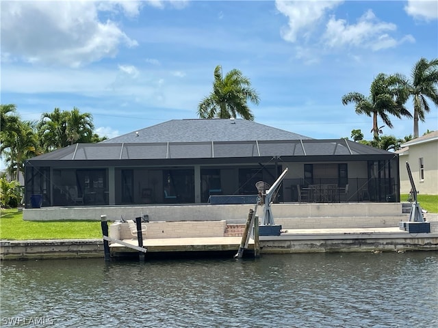 dock area with a lanai and a water view