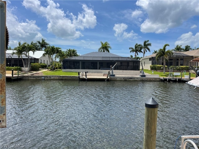 view of dock with glass enclosure and a water view