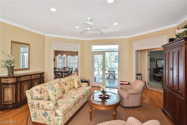 living room featuring crown molding, light hardwood / wood-style floors, and ceiling fan