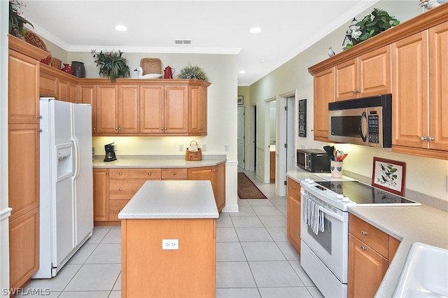 kitchen featuring a kitchen island, ornamental molding, white appliances, and light tile flooring