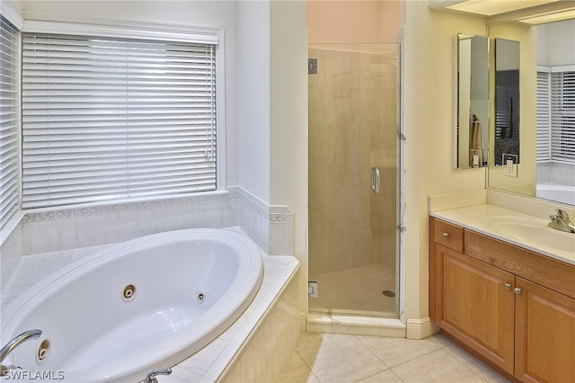 bathroom featuring tile flooring, oversized vanity, and plus walk in shower