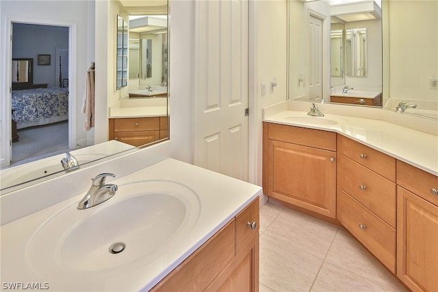 bathroom with oversized vanity, tile floors, and double sink