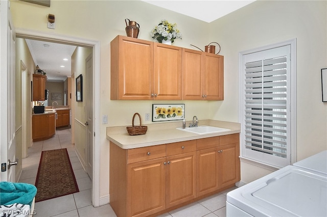 kitchen featuring sink, light tile floors, and washer / clothes dryer