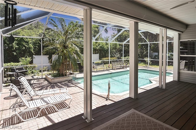 view of swimming pool featuring a lanai and a patio area