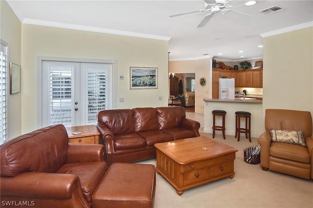 carpeted living room with french doors, ornamental molding, and ceiling fan