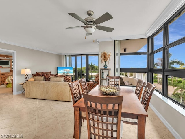 tiled dining space featuring a wall of windows, ceiling fan, and ornamental molding