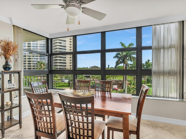 tiled dining room featuring a wall of windows, plenty of natural light, and ceiling fan