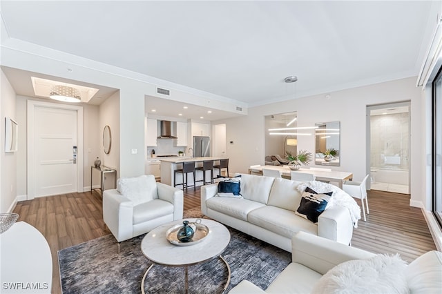 living room featuring crown molding and light wood-type flooring