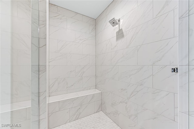 bathroom with a tile shower