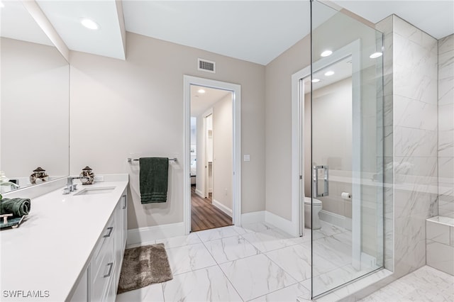 bathroom featuring vanity, toilet, and walk in shower