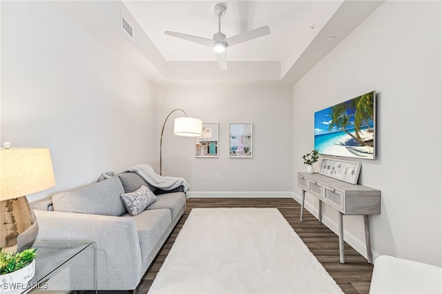 living room featuring ceiling fan and dark hardwood / wood-style floors