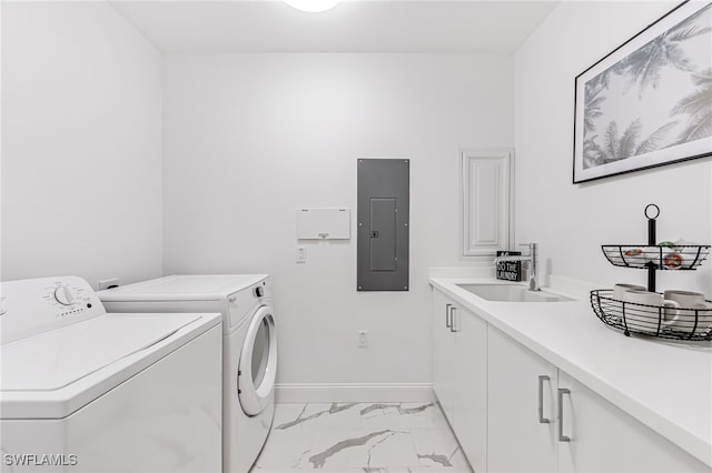 laundry area with cabinets, washing machine and dryer, sink, and electric panel