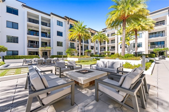 view of patio featuring an outdoor living space with a fire pit