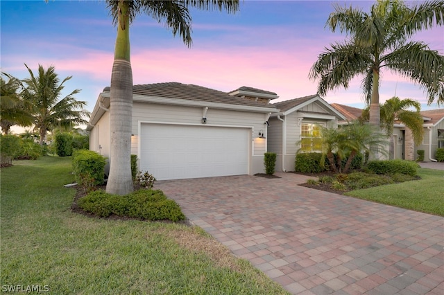 view of front facade with a yard and a garage