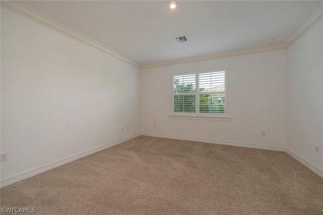 carpeted empty room featuring ornamental molding