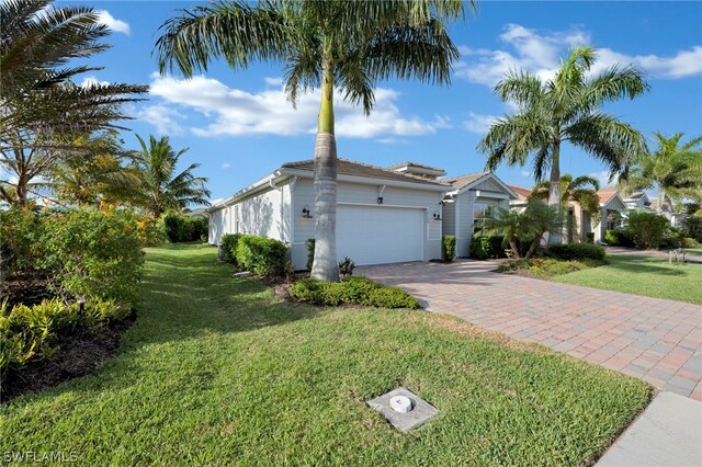 view of front of house with a garage and a front lawn