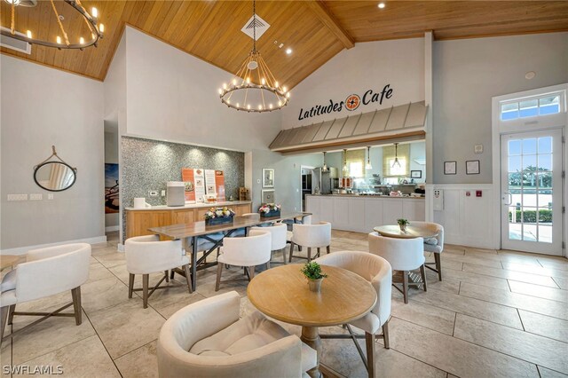 dining space featuring high vaulted ceiling, light tile flooring, wood ceiling, beam ceiling, and an inviting chandelier