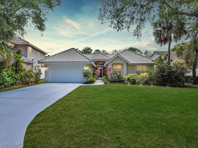 view of front of property featuring a yard and a garage