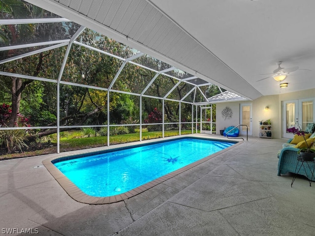 view of pool featuring a patio area, ceiling fan, and glass enclosure