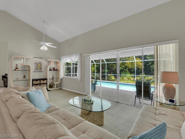 carpeted living room with high vaulted ceiling and ceiling fan