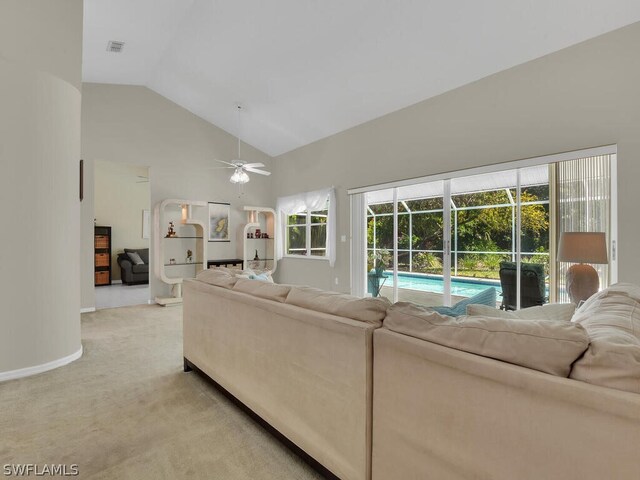 carpeted living room featuring high vaulted ceiling and ceiling fan