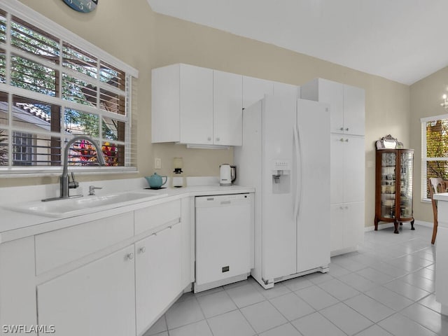 kitchen featuring light tile floors, sink, white appliances, white cabinetry, and lofted ceiling