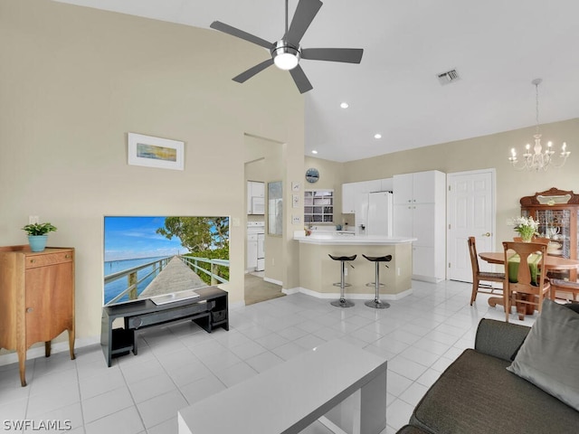 living room featuring ceiling fan with notable chandelier, high vaulted ceiling, and light tile floors