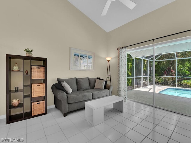 living room with high vaulted ceiling, ceiling fan, and light tile flooring